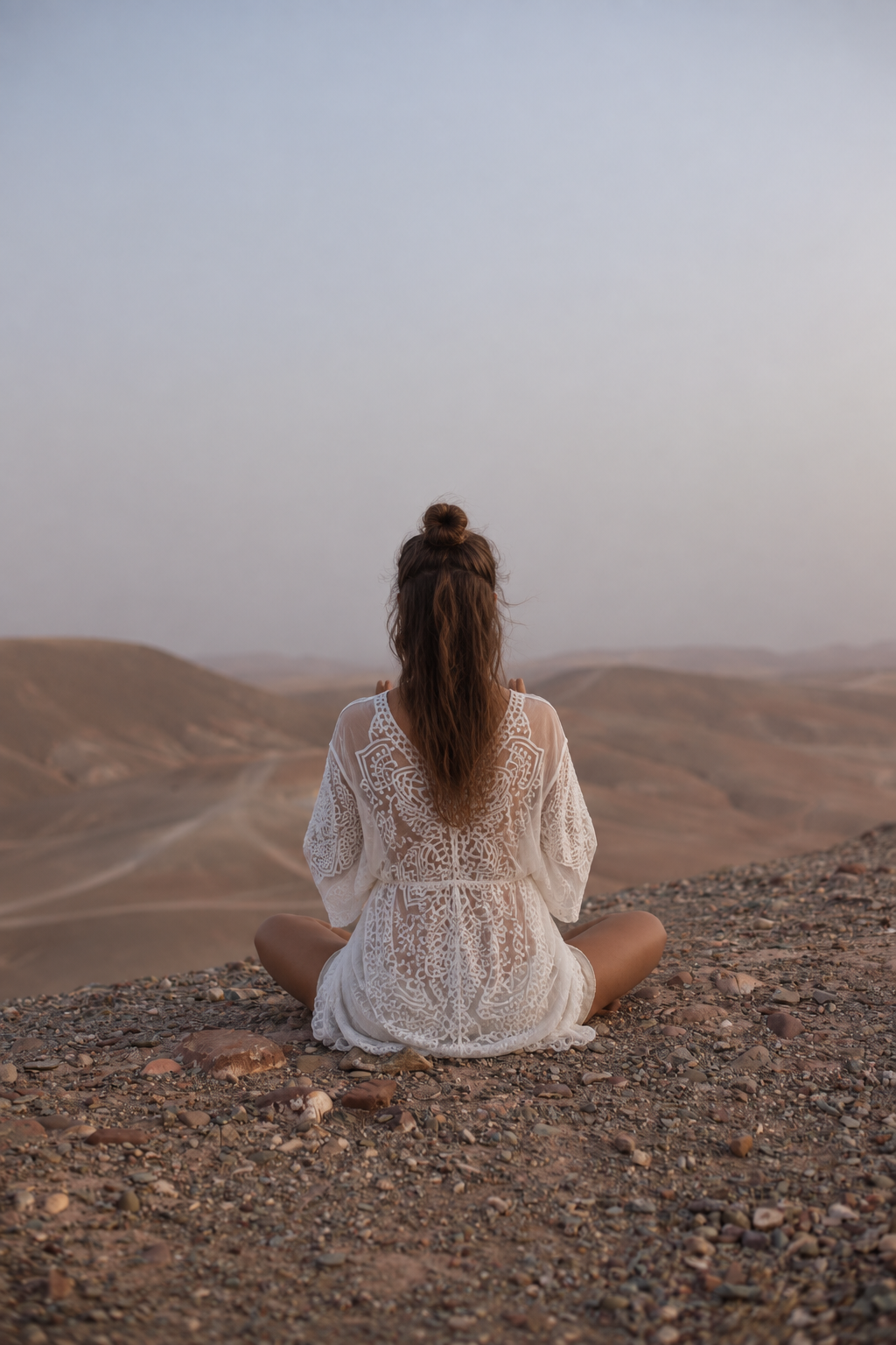 Zerina sitting peacefully, facing the Moroccan desert
